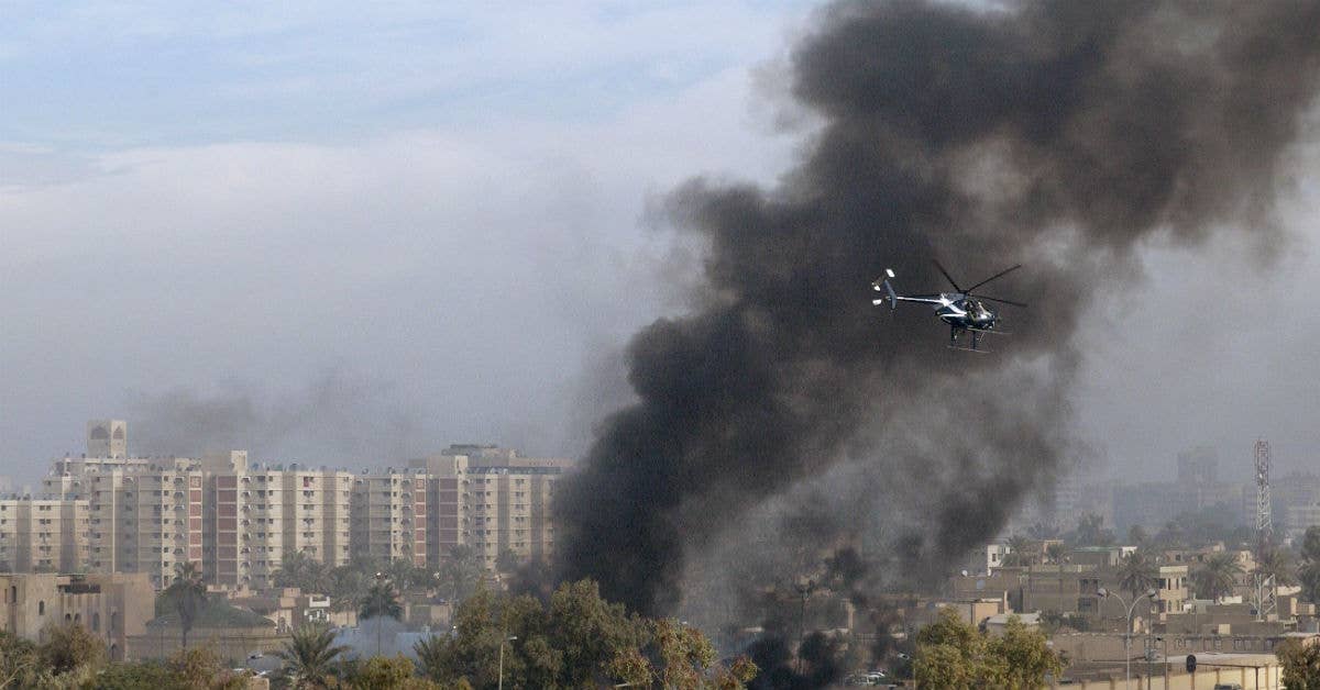 A Blackwater Security Company MD-530F helicopter aids in securing the site of a car bomb explosion in Baghdad, Iraq. USAF photo by Master Sgt. Michael E. Best