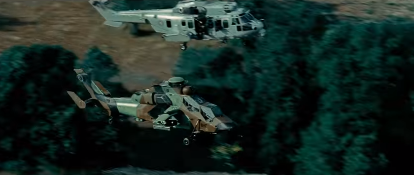 A Eurocopter Tigre escorts a transport helicopter. (Youtube Screenshot)