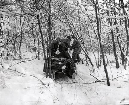 Medics remove an American casualty from the wood near Berle, Lusxembourg on Jan. 12, 1945
