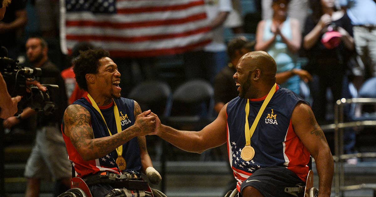 Retired US Marine Corps Sgt. Anthony McDaniel celebrates with retired Army Sgt. 1st Class Chuck Amsted after winning the wheelchair basketball championship against the United Kingdom at Invictus Games, Orlando, Fla., May 12, 2016. USAF Photo by Tech. Sgt. Joshua L. DeMotts.