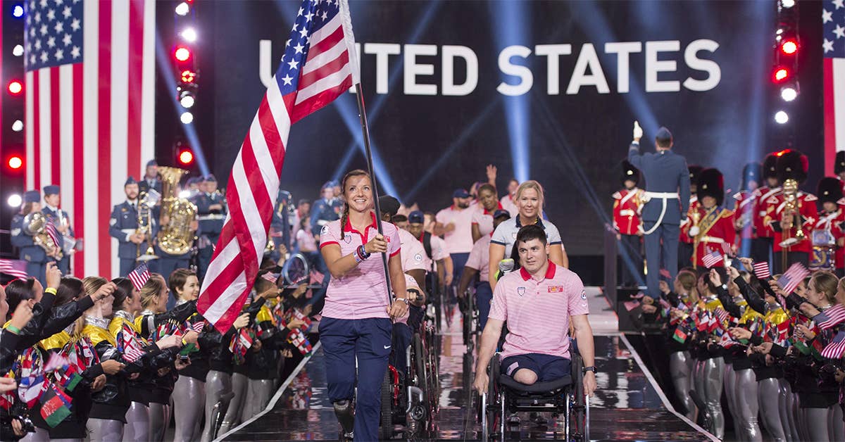 Air Force Capt. Christy Wise, US team captain, carries the American flag as her team enters the opening ceremony for the 2017 Invictus Games at the Air Canada Centre in Toronto, Sept. 23, 2017. At right is team co-captain Marine Corps Sgt. Ivan Sears. DoD photo by Roger L. Wollenberg.