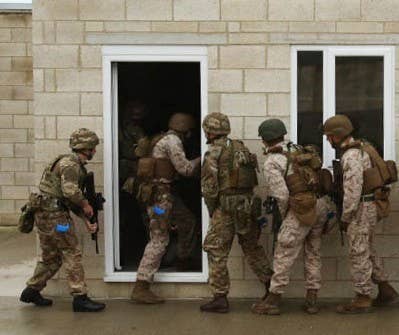 U.S. Marines and British Royal Commandos enter a building together in the first phase of security forces training in New Castle Upon Tyne, England, Sept. 21-25, 2015. (USMC photo)