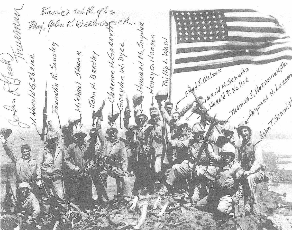 Eighteen young Marines stand atop Mt. Suribachi, Feb. 23, 1945. USMC photo by Joe Rosenthal.