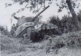 The Sherman tank wasn't known for its firepower, but it could easily deal with a few German dismounts. (Photo: U.S.Army)
