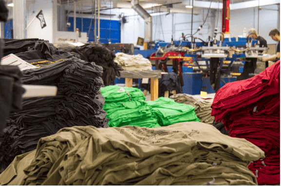 Piles of printed t-shirts sit ready to enter the fulfillment stage. (Photo: Grunt Style)