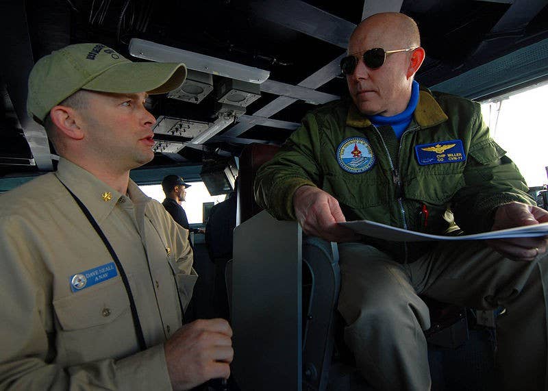 Officer of the Deck briefs the commanding officer on the bridge of the USS George H.W. Bush (CVN 77). (Photo: U.S. Navy)