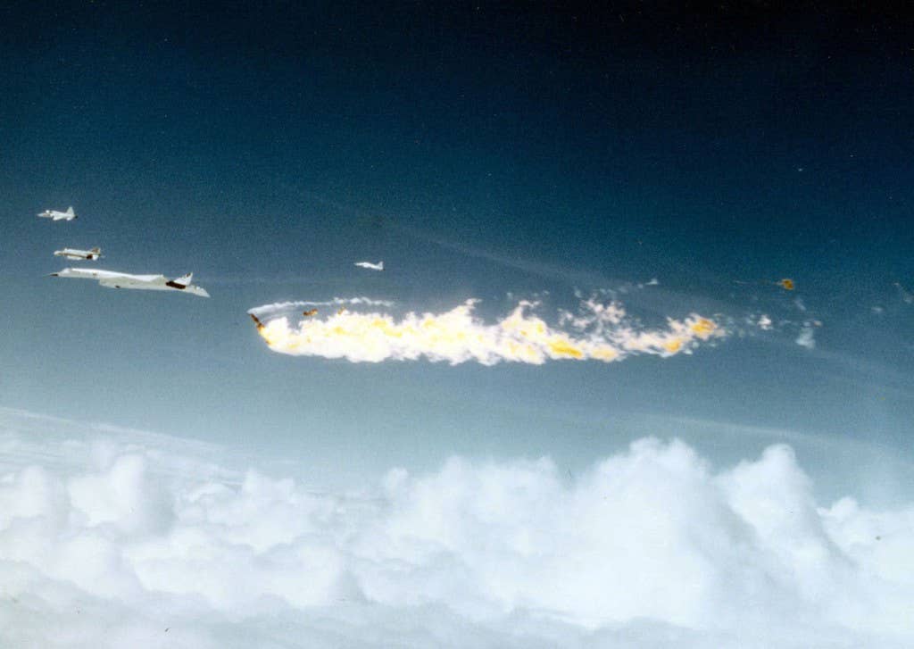 F-104 in flames after hitting the XB-70 during a PR formation flight over Edwards Air Force Base on June 8, 1966. (Official U.S.A.F. photo)