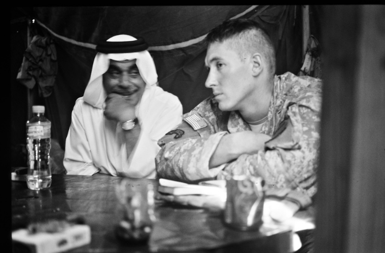 Another photo taken by civilian photojournalist Putnam, of a commander and a tribal sheikh meeting in Iraq