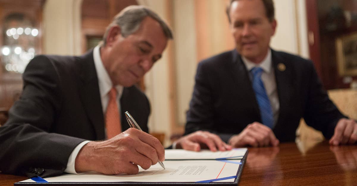 Speaker John Boehner signs H.R. 91, the Veterans Identification Card Act, sponsored by Rep. Vern Buchanan (R-MI). Photo from Speaker John Boehner Flickr.