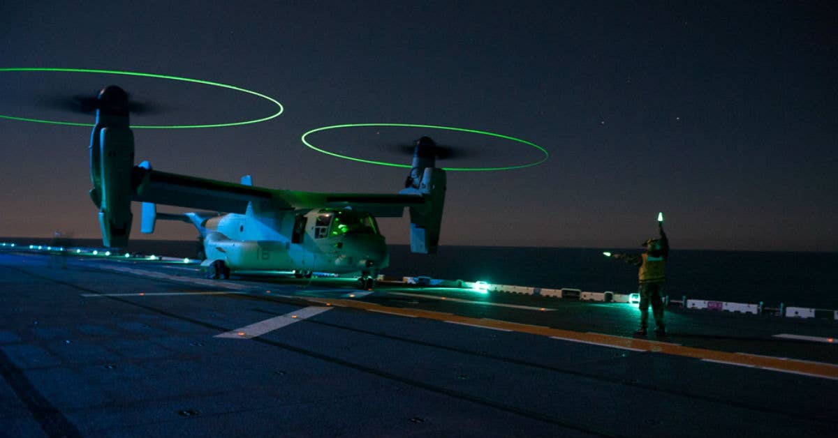 Flight deck personnel conduct night operations with MV-22 Osprey aircraft aboard the flight deck of the amphibious assault ship USS Boxer. Navy photo by Mass Communication Specialist 2nd Class Oscar Espinoza.