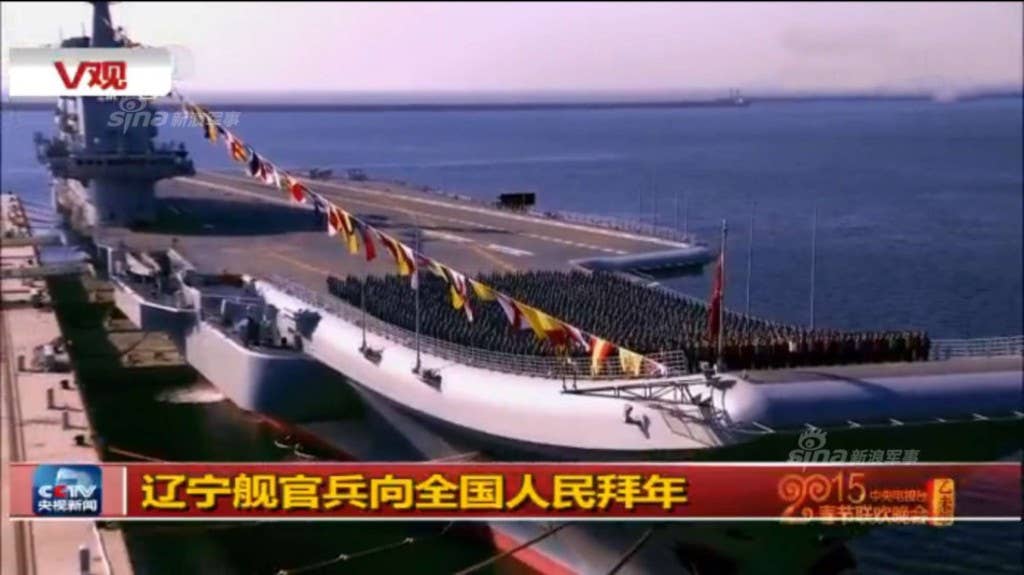 Troops gather on the deck of the Liaoning, China's single aircraft carrier.