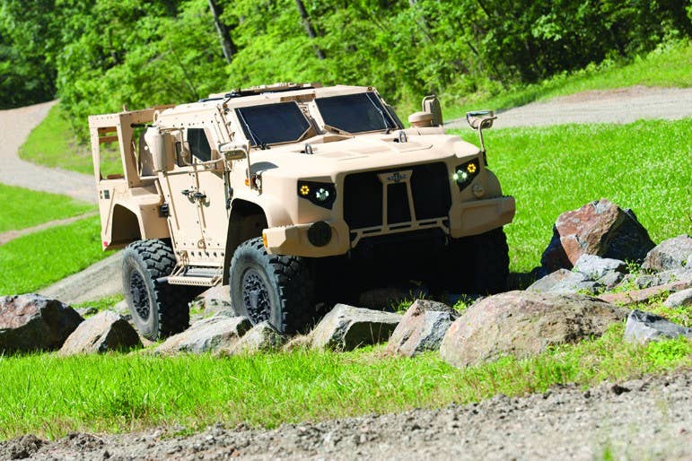 An Oshkosh Defense prototype of the Joint Light Tactical Vehicle negotiates an off-road demonstration course at Quantico, Va., in June 2013. The Oshkosh version beat out JLTV prototypes there from AM General and Lockheed Martin. | Photo courtesy Oshkosh Defense