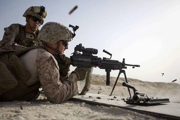 A U.S. Marine fires an M249 light machine gun. (U.S. Marine Corps photo by Sgt. Donald Holbert)
