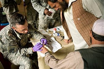U.S. Navy doctor, Lt. Cdr. Ashby, conducts a medical procedure on a local man.