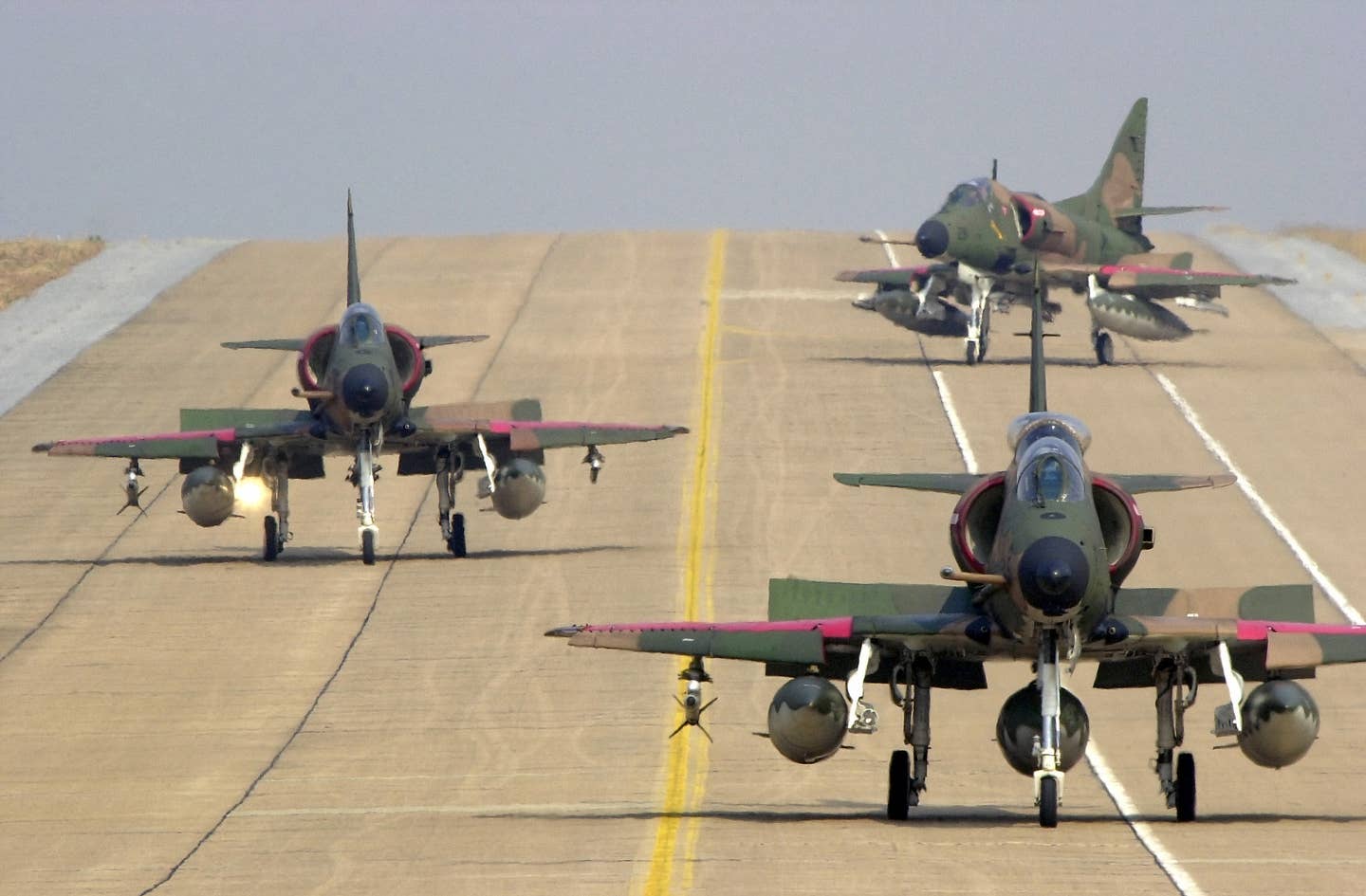 Three Republic of Singapore Air Force A-4SU Skyhawk aircraft taxi on the flight line at Korat AB, Thailand, during Exercise COPE TIGER '02. (USAF photo)