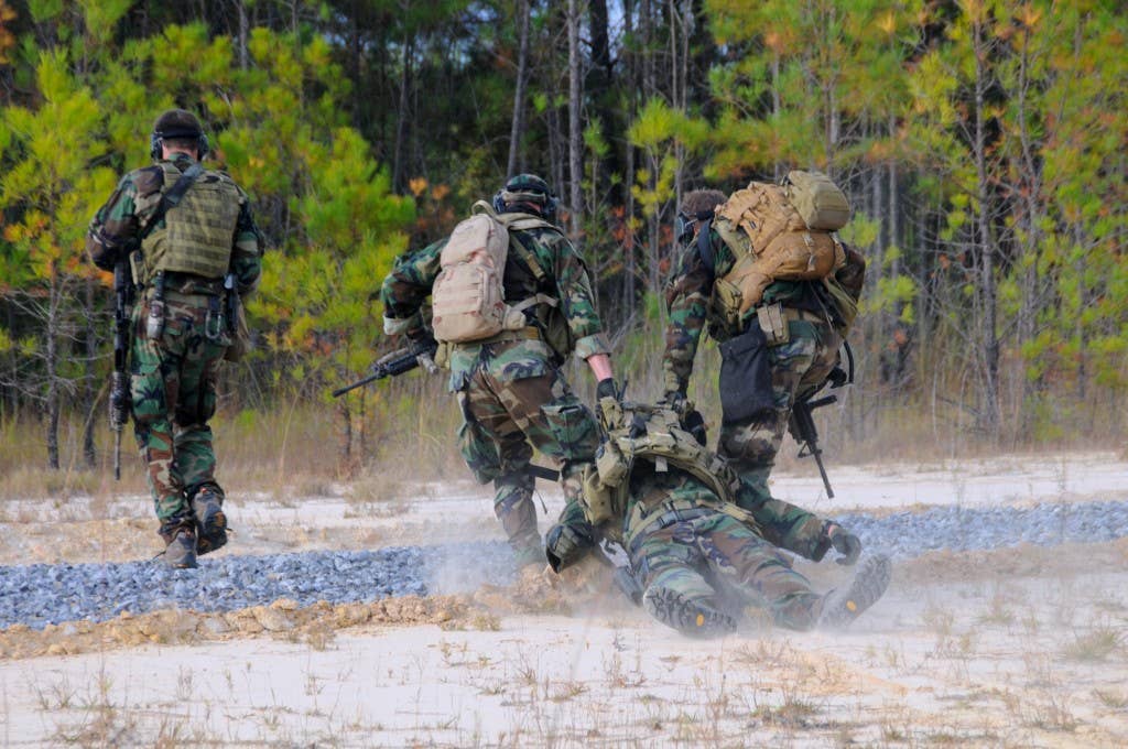 Navy SEALs simulate the evacuation of an injured teammate during immediate action drills at the John C. Stennis Space Center. The drills are a part of the SEALs pre-deployment training.