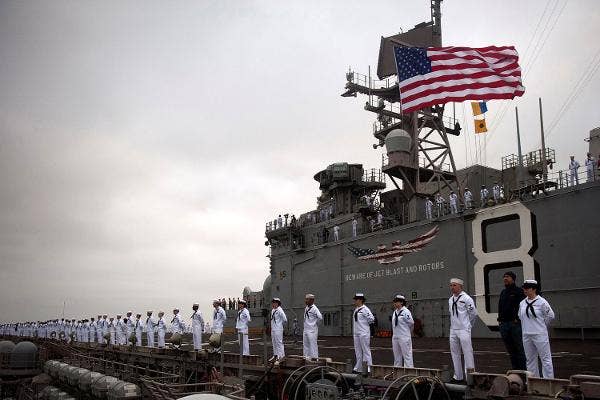 Sailors man the rails aboard the amphibious assault ship USS Makin Island (LHD 8) in 2012. | (Photo by Mass Communication Specialist 2nd Class Dominique Pineiro/Navy)