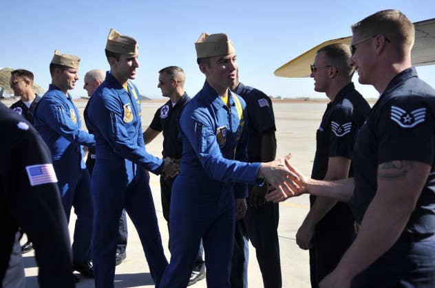 Blue Angels pilots greet Thunderbirds maintainers.