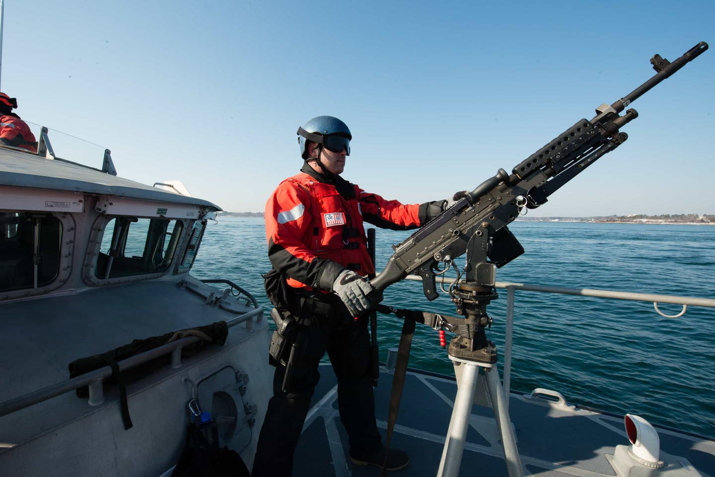 Petty Officer 2nd Class Robert Richey, a crewmember at Coast Guard Station Portsmouth Harbor, mans an M240B machine gun on the bow of a 47-foot Motor Lifeboat during a security escort into Portsmouth Harbor the morning of Thursday, Feb. 23, 2017. (U.S. Coast Guard photo by Petty Officer 3rd Class Andrew Barresi)