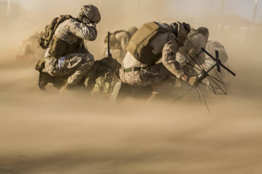 Marines brace themselves against rotor wash from a CH-53E Super Stallion during an embassy evacuation exercise. Photo: US Marine Corps Lance Cpl. Jodson B. Graves