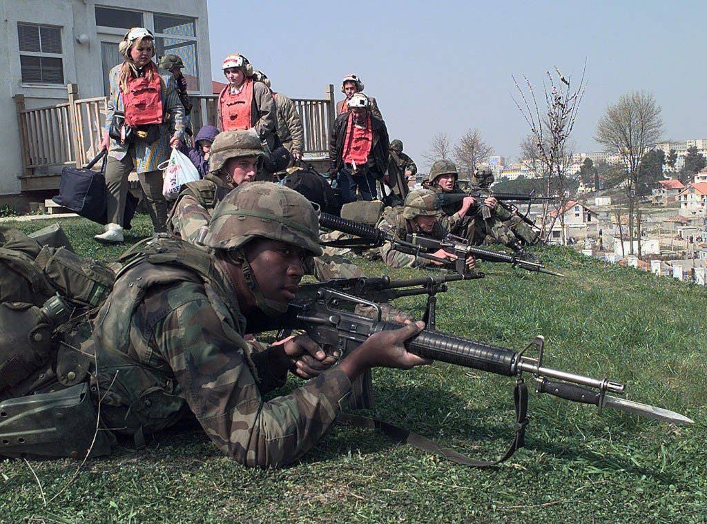Marines secure the exit route for civilian personnel inside the U.S. Embassy housing compound in Tirana, Albania, on March 15, 1997. Photo: US Navy Petty Officer 2nd Class Brett Siegel