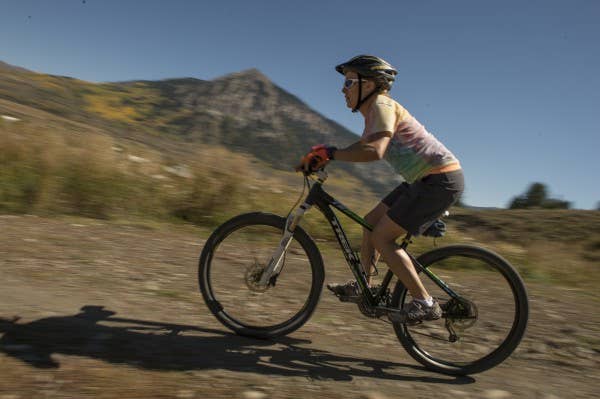 Retired Tech. Sgt. Jessica Moore rides her bicycle down a mountain trail during an adaptive sports camp in Crested Butte, Colo. The camp participants spent two full days completing bicycle trails and endurance activities. | Photo by Staff Sgt. Vernon Young Jr.