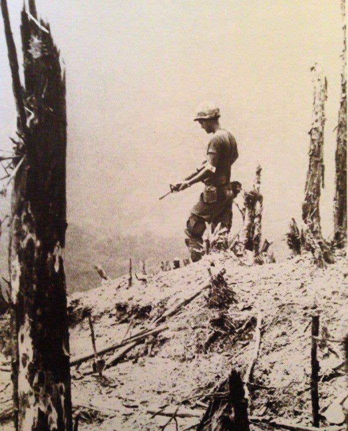 1972 - Marine on top of a war-torn hill after battle with NVA