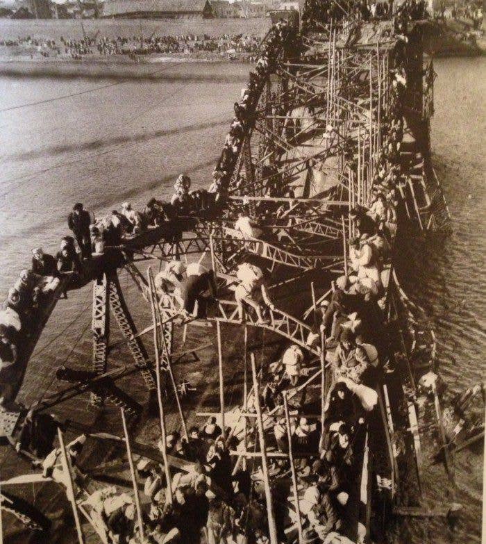 1951 - Refugees fleeing across the Taedong River during the Chinese invasion of North Korea