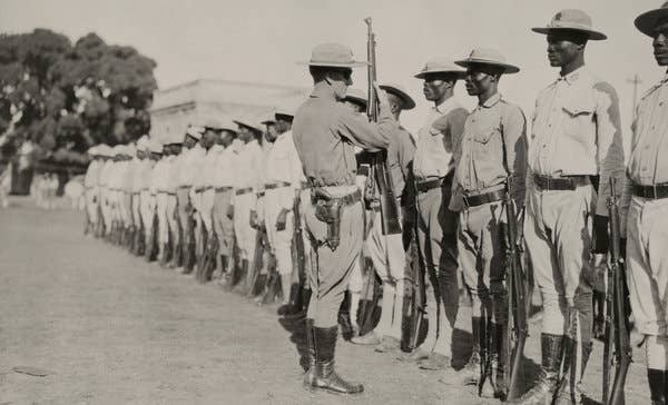 A U.S. Marine inspect Haitian soldiers, ca. 1915 (U.S. Marine Corps photo)