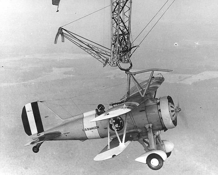 A Sparrowhawk fighter hanging underneath the USS Macon airship during testing (US Navy)
