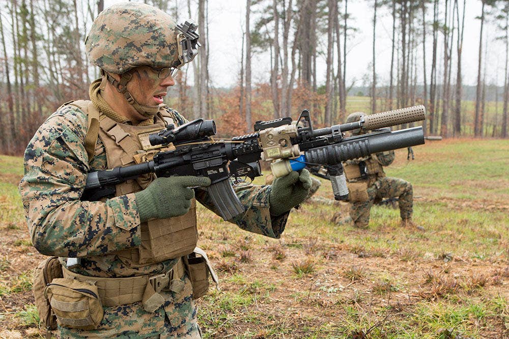 U.S. Marine Corps Lance Cpl. William Jaggers, rifleman, Lima Company, 3rd Battalion, 8th Marine Regiment, 2nd Marine Division (2d MARDIV), loads an M203 grenade launcher during a live-fire range at the Infantry Platoon Battle Course as part of a Deployment for Training (DFT), on Fort Pickett, Va., Dec. 12, 2016. (U.S. Marine Corps photo by Lance Cpl. Alexis C. Schneider, 2d MARDIV Combat Camera)