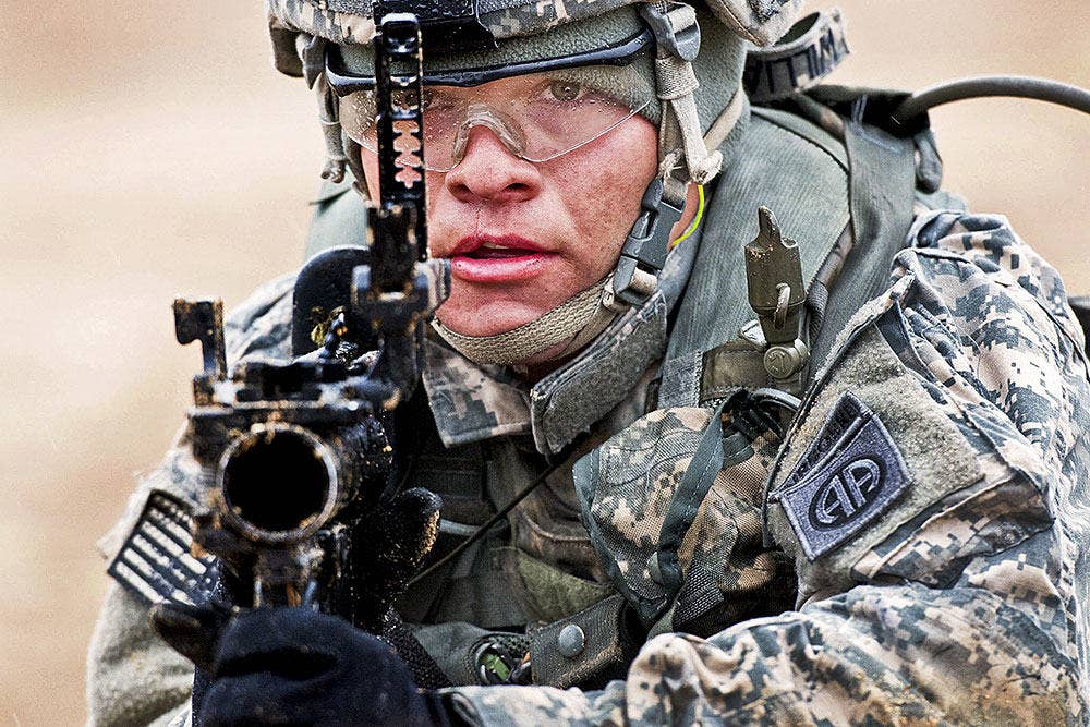 Spc. Travis Williams, a grenadier with the 1st Brigade Combat Team, 82nd Airborne Division, looks through the the sights of his M320 grenade launcher March 24, during a training exercise at Fort Bragg, N.C. (U.S. Army photo by Sgt. Michael J. MacLeod)