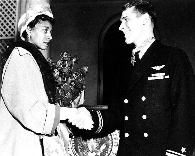 Mrs. Daisy P. Brown congratulates Hudner after he is awarded the Medal of Honor.
