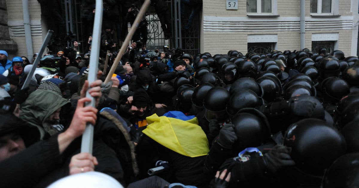 Soldiers of Ukraine's Internal Troops in riot gear and protesters clash at Bankova str, Kiev, Ukraine. December 1, 2013. (Photo by Mstyslav Chernov)