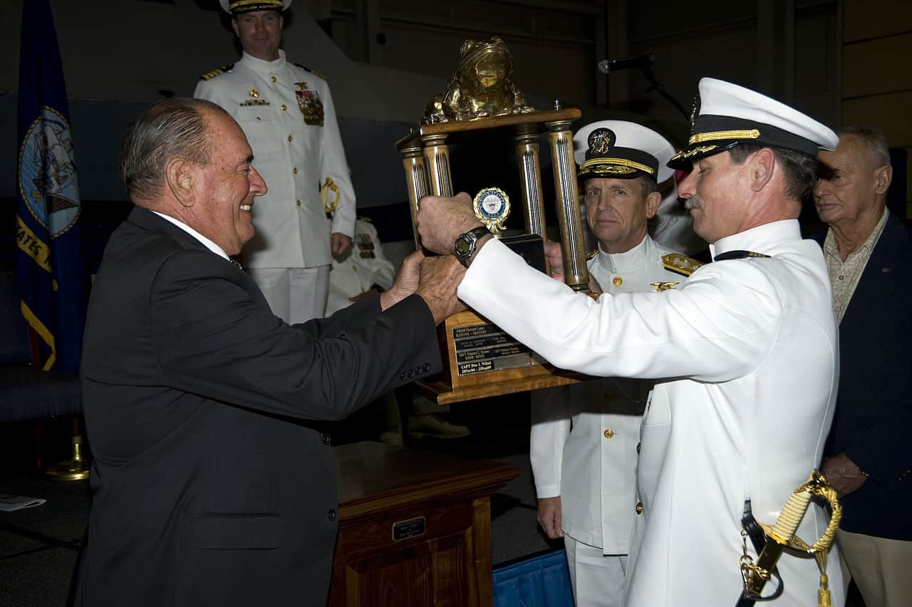 Retired Rear Adm. Dick Lyon, the first Bullfrog, left, passes the Bullfrog trophy to Capt. Pete Wikul, the 13th Bullfrog, during the passing of the Bullfrog ceremony. The title Bullfrog recognizes the UDT/SEAL operator with the greatest amount of cumulative service. Wikul retired after 39 years and 4 months of Navy service. (U.S. Navy photo by Mass Communication Specialist 2nd Class Joshua T. Rodriguez)