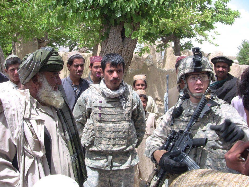 Soldiers speaking with locals