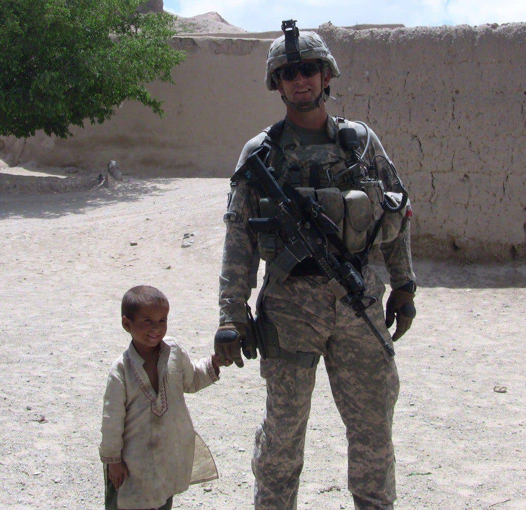 Soldiers with a civilian child