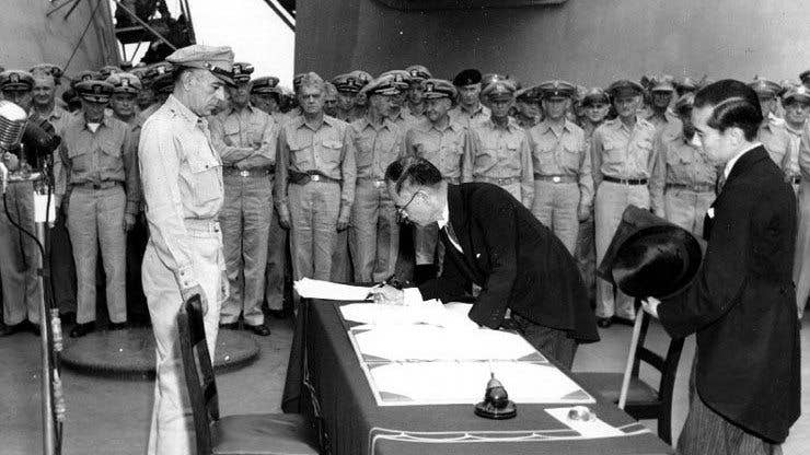 Japanese reps sign the article of surrender aboard the USS Missouri anchored in Tokyo Bay. (Photo: Wikimedia Commons)