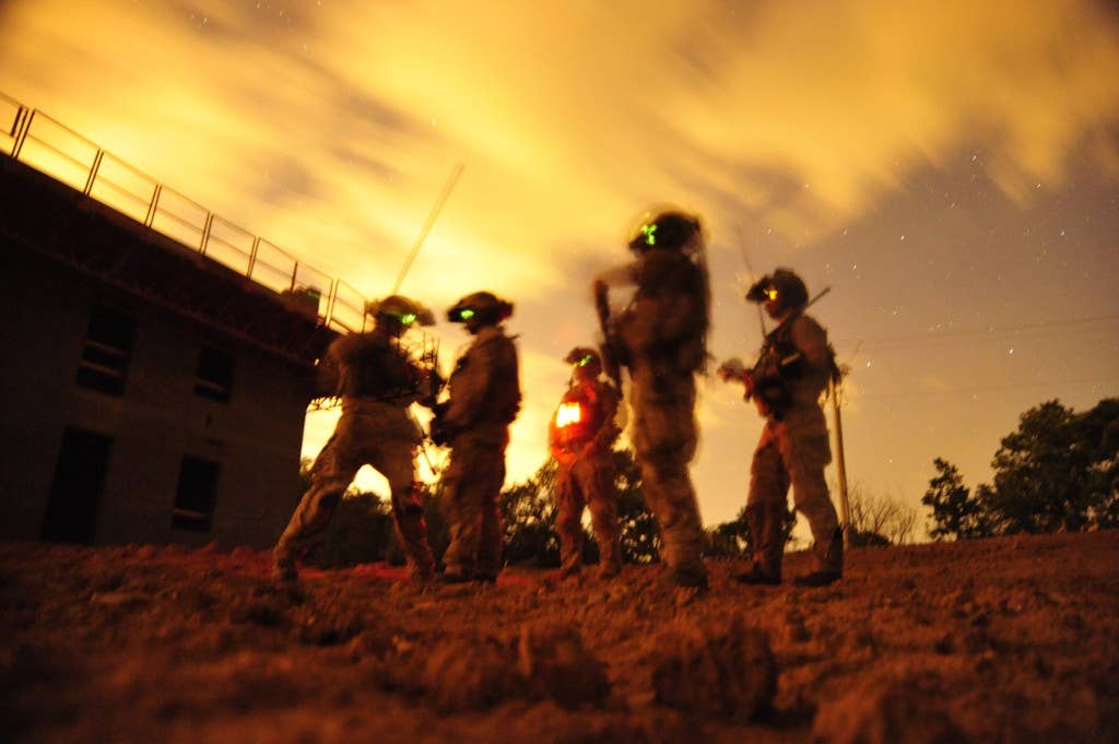 A squad of U.S. Navy SEALs participate in Special Operations Urban Combat training. The training exercise familiarizes special operators with urban environments and tactical maneuvering during night and day operations.