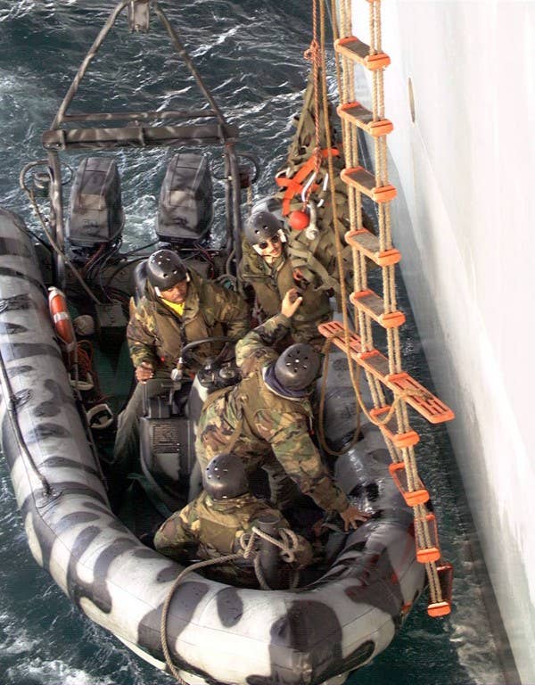 U.S. Navy SEALs from Naval Special Warfare Group Two rehearse ship-to-ship boarding procedures using Zodiac RIB boats deployed from the coastal patrol boat USS Chinook (PC 9), on April 28, 1996, during Combined Joint Task Force Exercise '96. More than 53,000 military service members from the United States and the United Kingdom are participating in Combined Joint Task Force Exercise 96 on military installations in the Southeastern United States and in waters along the Eastern seaboard. DoD photo by Mike Corrado