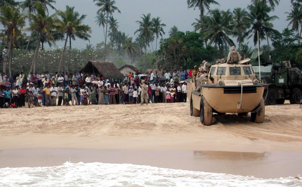 Colombo, Sri Lanka (Jan. 10, 2005) - A U.S. Marine Corps amphibious vehicle prepares to bring Marines and Sailors aboard an awaiting Landing Craft Utility (LCU) at the end of the day's relief efforts in Colombo, Sri Lanka. Helicopters from USS Bonhomme Richard (LHD 6) and Marines and Sailors assigned to 15th Marine Expeditionary Unit are supporting Operation Unified Assistance, the humanitarian operation effort in the wake of the Tsunami that struck South East Asia. The Bonhomme Richard Expeditionary Strike Group is currently operating in the Indian Ocean off the waters of Indonesia and Thailand. U.S. Navy photo by Lance Cpl. Joseph Ward (RELEASED)