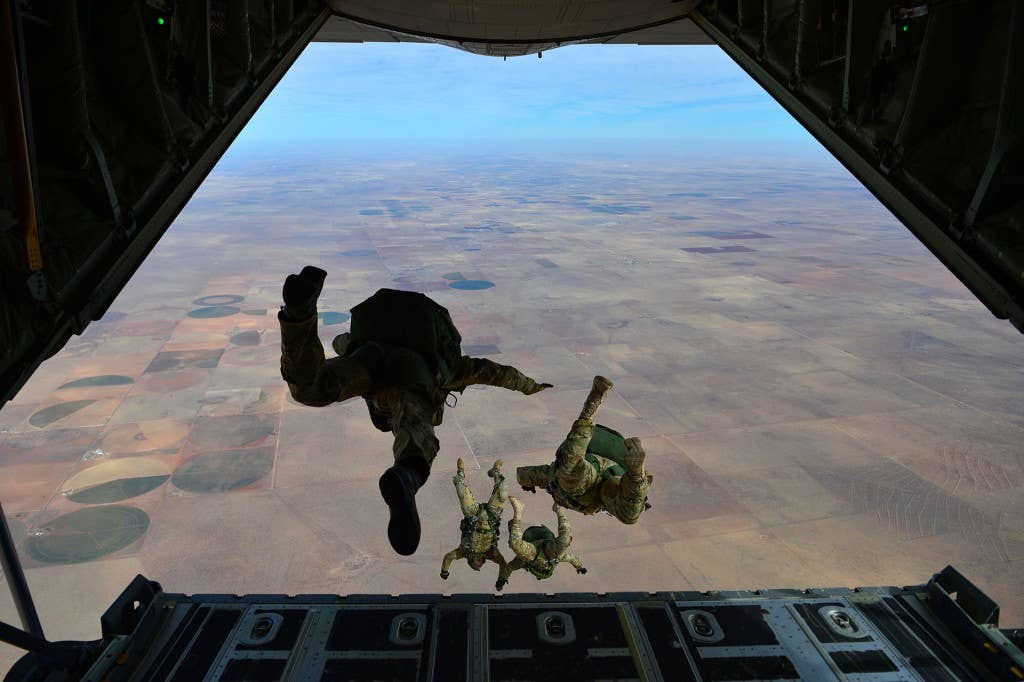 Members of the Air Force's 26th Special Tactics Squadron jump out of an MC-130.