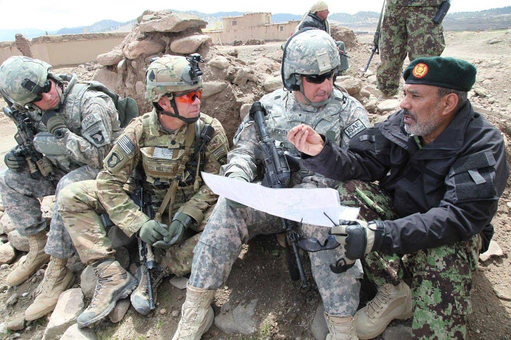 U.S. Army soldiers in May 2011, wearing the ACU in the Universal Camouflage Pattern, along with its replacement Multicam pattern (second from left) in Paktika province, Afghanistan. (Photo: Spc. Zachary Burke)