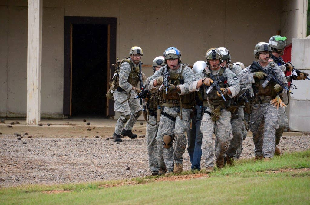 Special Forces candidates maneuver out of a compound during training. Photo: US Army Sgt. Justin P. Morelli