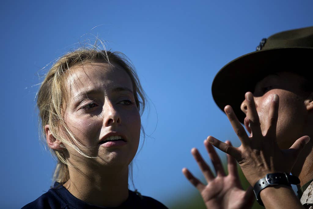 Samantha Holmberg, a Marine enlistee from Auburn, Wash., responds to a command from Sgt. Tina Quevedo, a drill instructor from Marine Corps Recruit Depot Parris Island, S.C., during a Recruiting Station Seattle pool function at the Yakima Training Center in Yakima, Wash., July 17, 2015. During the event, recruiters teamed with drill instructors to physically and mentally prepare enlistees from Washington and Idaho for boot camp. The enlistees, part of the Marine Corps delayed entry program, are awaiting their ship dates. Holmberg, 18, graduated from Auburn High School and was recruited by Sgt. Thomas Bell. Quevedo, 24, is from Long Beach, Calif., and is assigned to November Company, 4th Recruit Training Battalion. (U.S Marine Corps photo by Sgt. Reece Lodder)