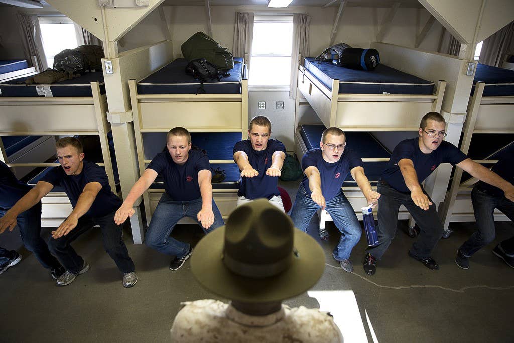 Sgt. Donald Jackson (center), a drill instructor from Marine Corps Recruit Depot San Diego, teaches Marine enlistees discipline during a Recruiting Station Seattle pool function at the Yakima Training Center in Yakima, Wash., July 17, 2015. During the event, recruiters teamed with drill instructors to physically and mentally prepare enlistees from Washington and Idaho for boot camp. The enlistees, part of the Marine Corps delayed entry program, are awaiting their ship dates. Jackson, 28, is from Suffolk, Va. (U.S Marine Corps photo by Sgt. Reece Lodder)