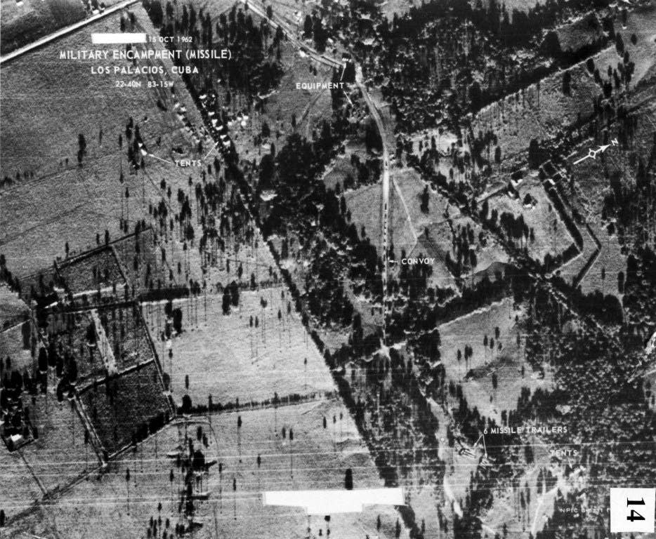 Soviet truck convoy deploying missiles near San Cristobal, Cuba, on Oct. 14, 1962. This image, taken by Maj. Steve Heyser in a USAF U-2, is the first picture that proved Russian missiles were being emplaced in Cuba. The image is dated on the day it was printed. (U.S. Air Force photo)