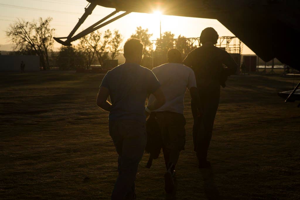 Role players are led by a Marine into a CH-53E Super Stallion during an embassy evacuation exercise. Photo: US Marine Corps Lance Cpl. Jodson B. Graves