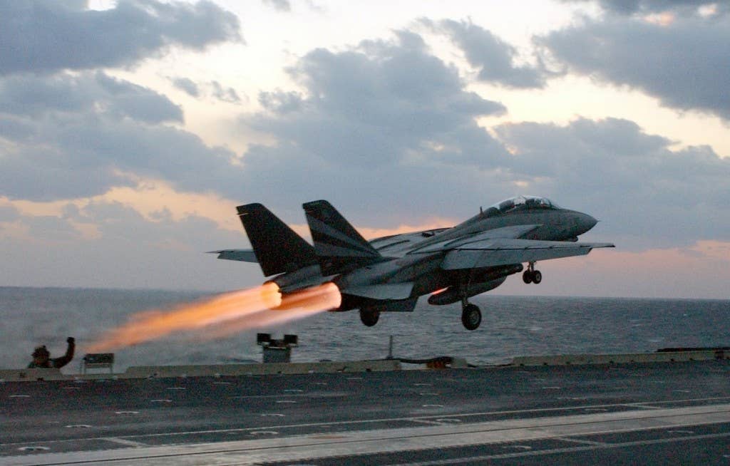 <a href="https://commons.wikimedia.org/wiki/Category:F-14_Tomcat_aircraft_carrier_launches#/media/File:US_Navy_021114-N-1810F-018_An_F-14_%5Eldquo,Tomcat%5Erdquo,_assigned_to_the_%5Eldquo,Black_Knights%5Erdquo,_of_Fighter_Squadron_One_Five_Four_(VF-154)_launches_past_steaming_catapults_on_the_bow_of_the_ship.jpg" target="_blank" rel="noreferrer noopener">U.S. Navy Photographer’s Mate 3rd Class Todd Frantom via Wikimedia Commons</a><br>