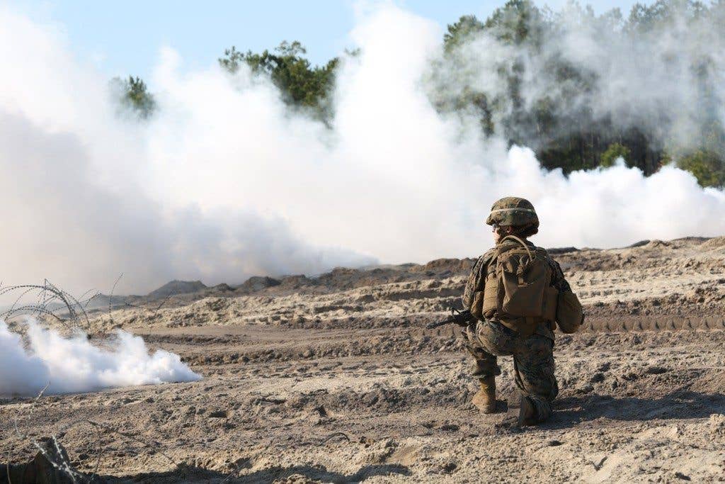 Cpl. Jade Nichols, combat engineer, Engineer Platoon, Headquarters and Service Company, Ground Combat Element Integrated Task Force, provides security under the concealment of a smoke grenade during a field training exercise aboard Marine Corps Base Camp Lejeune.(U.S. Marine Corps photo by Cpl. Paul S. Martinez/Released)